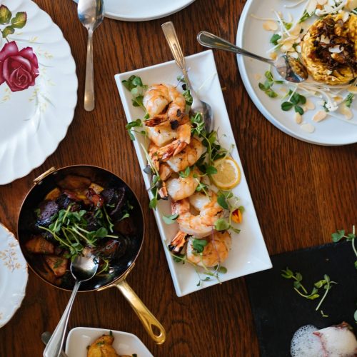 An overhead view of a beautifully arranged dining table featuring various gourmet dishes, perfect for a culinary experience.